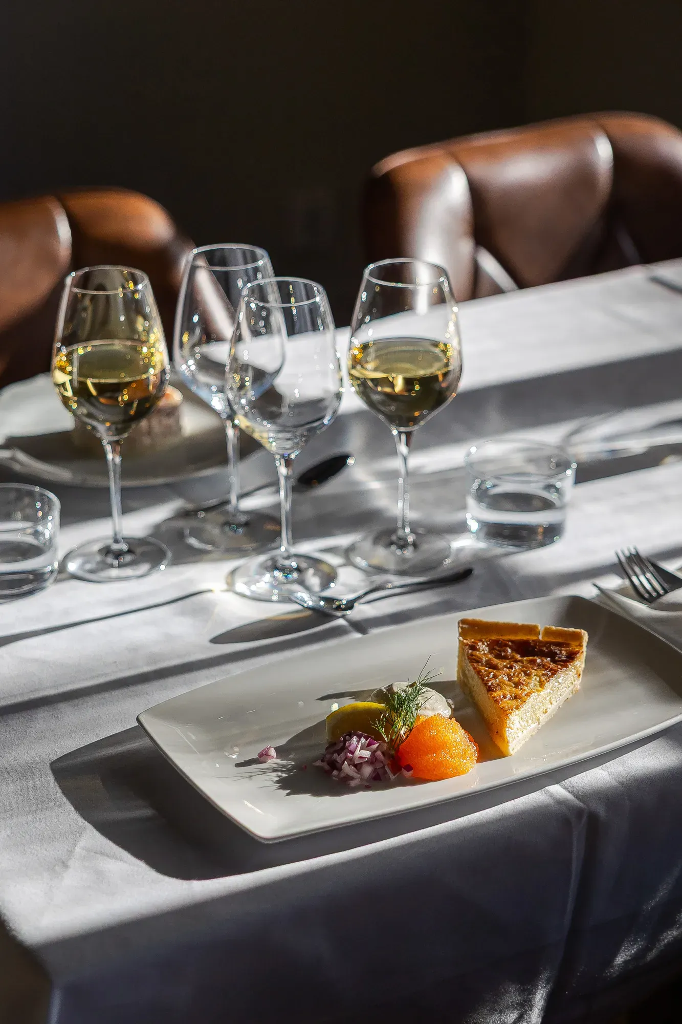 Gedeckter Tisch mit Essen und Wein im Herrenhausrestaurant.